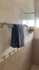 a bathroom with a shower with a blue towel at Hospedaje Casa Wichel, Calida y Bohemia tu mejor opsion in Ciudad Valles +28 photos