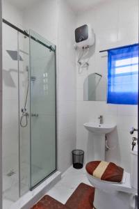 a bathroom with a shower and a toilet and a sink at Shortlet spaces in Lagos