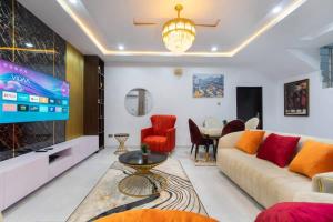 a living room with a couch and a tv at Shortlet spaces in Lagos