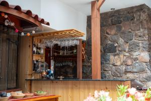 a bar with a stone wall at Casa Antade Cusco in Cusco