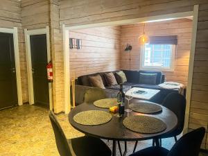 a living room with a table and a couch at MIDGARD LODGE - Pre-Heated with Ready Beds at Bjorli in Bjorli