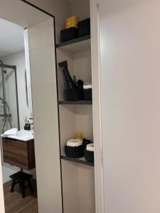 a bathroom with a mirror next to a sink at Apartamento Manzana in Seville +15 photos