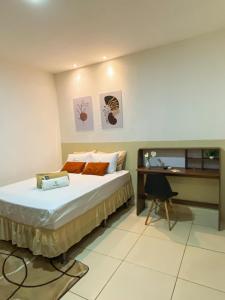 a hotel room with a bed and a desk at Hotel Leda Rafael in João Câmara