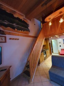 a room with a staircase in a house at casa claudio-APPARTAMENTI IN CENTRO in Campitello di Fassa