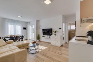 a white living room with a couch and a table at Villa Corcovado Deluxe Apartments with Heated Pool in Vodice +41 photos