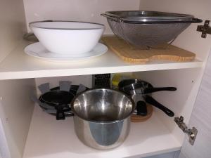 a shelf with a bowl and other kitchen utensils at La Casa di Gio ed Eli in Voghera