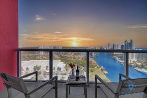 a balcony with a table and chairs and a view of a river at Amazing Balcony Near Beach in Hallandale Beach
