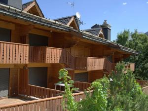 a large wooden building with balconies on it at Charmant appartement 3* à Courchevel Village, idéal pour familles - Proche Aquamotion, 4 pers. - FR-1-575-9 in Courchevel +13 photos
