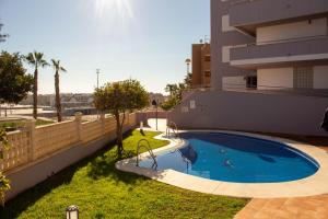 a swimming pool on the side of a building at SpainKarmaSun in Torrox Costa