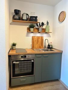 a kitchen with a sink and a stove at Loft Apartment New York in Donaueschingen +7 photos