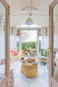 a living room with a table and chairs at Pocket Cottage Luxury 18th Century Tiny Home in Picturesque Village with Pubs in Stillington