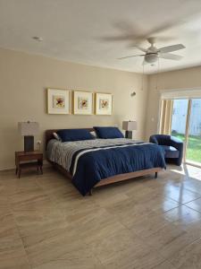a bedroom with a bed and a ceiling fan at Casa Victoria Cozumel in Cozumel