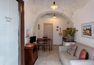 a living room with a couch and a table at Pietra e Sogni Coppia in Alberobello +7 photos
