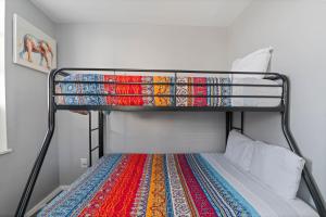 a bunk bed with a colorful rug on it at The Oakden Suites in Orange Loop A5 in Atlantic City +7 photos