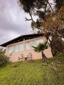 a house with two chairs in front of it at Inviting & Elegant Beach House in San Miguel