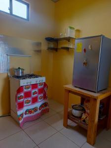 a kitchen with a refrigerator next to a stove at Casa de Tania in Puerto Baquerizo Moreno
