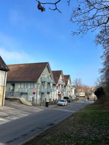 a street of houses with a car parked on the road at Loft Apartment New York in Donaueschingen