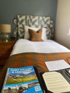 a book on a table next to a bed at Torlinnhe in Fort William +62 photos