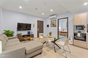 a living room with a couch and a table at Eagle Beach - Cozy Executive 1BR condo - LV102 in Palm-Eagle Beach