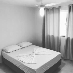 a white bed in a bedroom with a window at Residencial Veleiros Do Mar in Capão da Canoa +41 photos