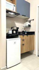 サン・カルロスにあるApartamento com piscina proximo a USP E UFSCarの白い冷蔵庫と電子レンジのあるキッチン