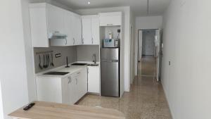 A kitchen or kitchenette at Apartamentos Bello Lanzarote