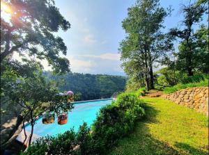 a swimming pool in the middle of a yard with trees at Casa Massaryk with Incredible Mountain Views in Santa Ana