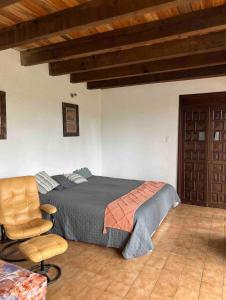 a bedroom with a bed and a chair at Casa Massaryk with Incredible Mountain Views in Santa Ana +78 photos