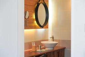 a bathroom with a sink and a mirror at Ilo Pension in Seogwipo +33 photos