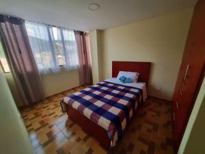 a small bedroom with a bed and a window at Edificio K&C in Sogamoso