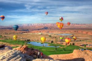 a group of hot air balloons flying over the desert at Local VIEW Pet Friendly BOAT Parking Close to Antelope Canyon HorseshoeBend in Page