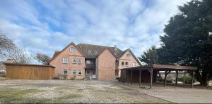 a large brick house with a garage in front of it at Bei den Leuchttürmen in Fehmarn