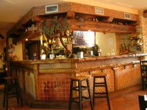 a bar in a restaurant with stools at Hostal Xaloa Orio in Orio