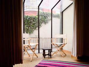 a room with two chairs and a window at Casa Bolivia Mundo B&B in La Paz