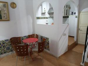 a kitchen with a table and chairs in a room at Maison Sevilla in Larache
