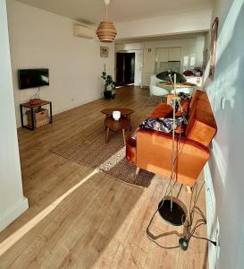 a living room with a couch and a table at New Seaview Luxury Apartment - Torre Marimar in Costa da Caparica