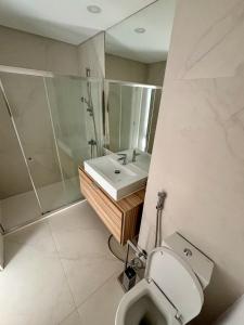 a bathroom with a sink and a shower and a toilet at New Seaview Luxury Apartment - Torre Marimar in Costa da Caparica