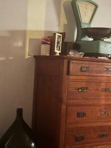 a wooden dresser with a mirror on top of it at L'Oasi di Pace di Elena in Ottone