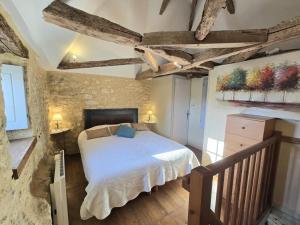 a bedroom with a bed in a stone wall at Séjour Authentique au Pigeonnier avec Wifi et Parking - FR-1-616-101 in Monsac