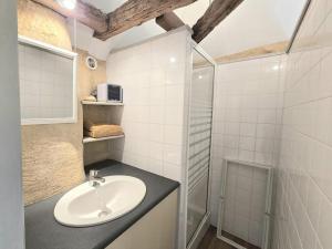 a bathroom with a sink and a shower at Séjour Authentique au Pigeonnier avec Wifi et Parking - FR-1-616-101 in Monsac