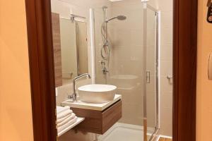 a bathroom with a sink and a shower at Manuel's House in Legnano