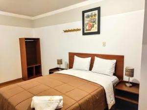 En eller flere senge i et værelse på Hotel El Gran Patriarca