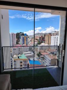 a room with a view of a city from a balcony at Intower en Sopocachi in La Paz