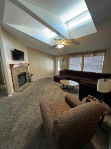 a living room with a couch and a fireplace at Cliff Hanger, River access with dock in Parker