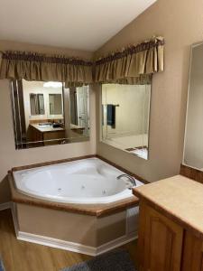 a large bathroom with a tub and a large mirror at Cliff Hanger, River access with dock in Parker +13 photos