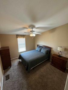 a bedroom with a bed and a ceiling fan at Cliff Hanger, River access with dock in Parker