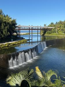 a bridge over a river with a waterfall at Luxurious 2-Bedroom Condo in Nuevo Vallarta 