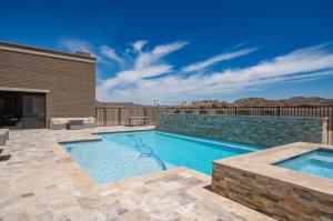 a swimming pool in a yard with a brick wall at Eagles Lair, Poolside Luxury! in Parker
