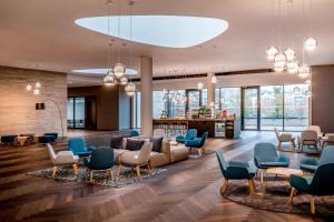 a lobby with a couch and chairs at Courtyard by Marriott Brno in Brno