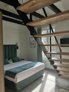 a bedroom with a large bed and a staircase at La lumière de Paris in Levallois-Perret
